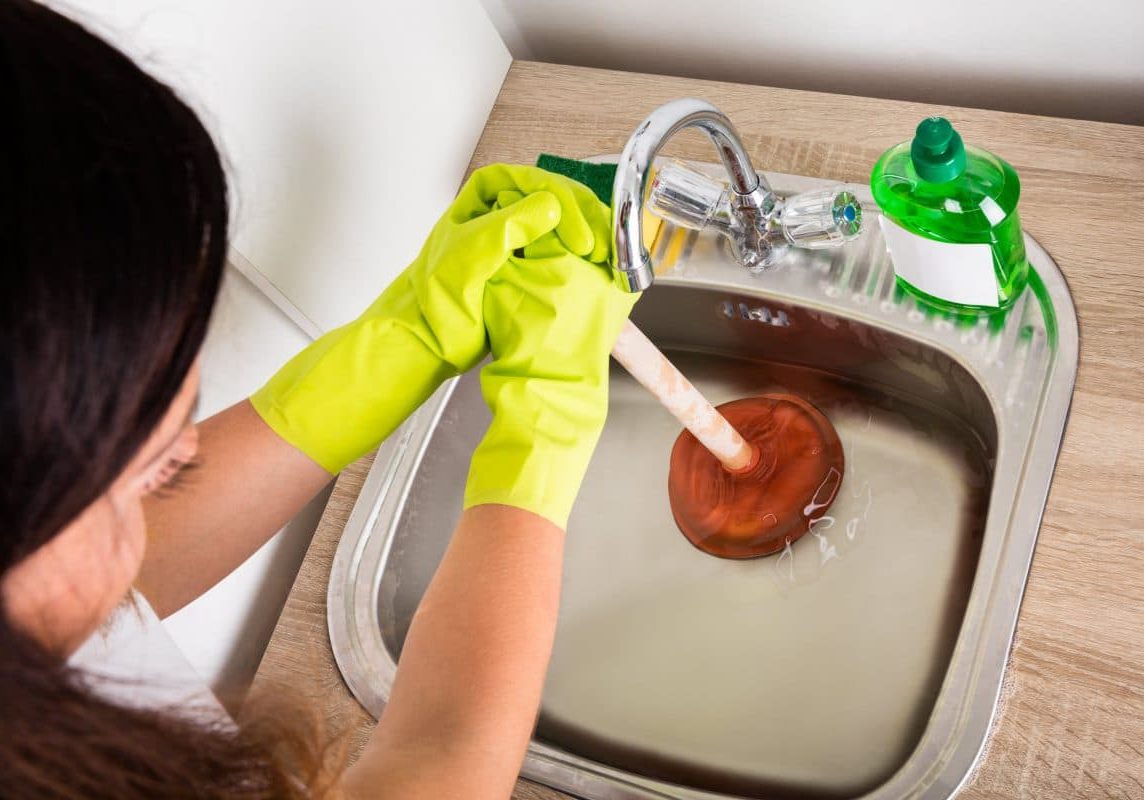 Blocked and clogged drains fixing with plunger.