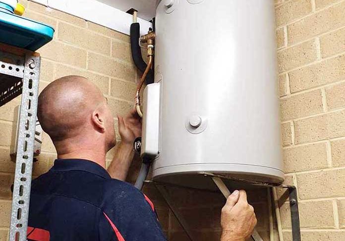 plumber installing an electric hot water heater